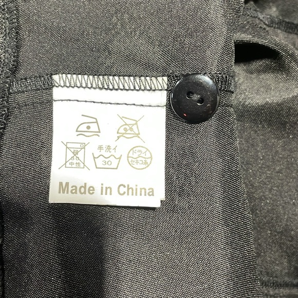 Ladies high neck sleeveless ruffle front top with corset detail in back. - Picture 4 of 5